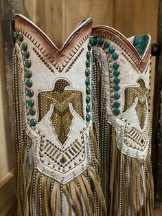 Irresistible, stunning, and flirty. This Corral Women's beige boot is a great choice for a fun night or an every day edgy style sure to catch everyones eye. This 14-inch shaft with its fun chain and leather fringe, turquoise studs, tan embroidery, and crystals will have you turning everyones head to admire them.You can wear this style all day without worrying about getting tired. It features; sturdy pull-on straps and an elegant snip toe. The smooth inside leather lining, cushioned leather insole, leather outer sole with a rubber insert and rubber heel cap, and 2 1/2 -inch stacked heel, scream comfort. Lightly cushioned footbed Fun chain and leather fringe Crystal Accents 14" shaft Snip toe 15" calf circumference 2.75" heel Vamp: Cowhide Cowboy Heel Leather Sole Punchy Western Outfits, Snip Toe Cowgirl Boots, Western Boots For Women, Fringe Cowboy Boots, Turquoise Crystals, Boots 2024, Cowgirl Boots Outfit, Cowgirl Couture, Beige Boots