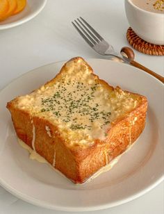 there is a piece of bread with cheese on it and a fork next to it