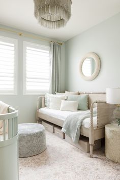 a baby's room with a crib, bed, and chair in it