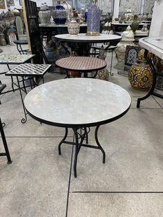 several tables and chairs are on display in a store