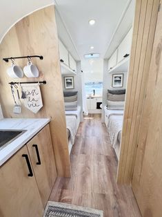 the interior of a camper with wood flooring