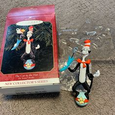 a cat in the hat figurine next to a boxed box with it's contents