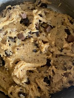 a metal bowl filled with batter and chocolate chips