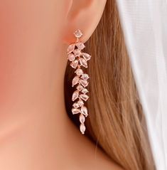 a pair of pink crystal earrings on top of a mannequin's head