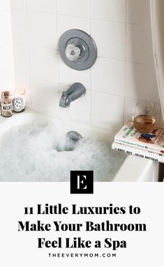 a bathtub filled with bubbles and soap next to a book on top of the tub