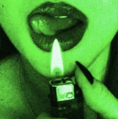 a woman holding a lighter in her mouth