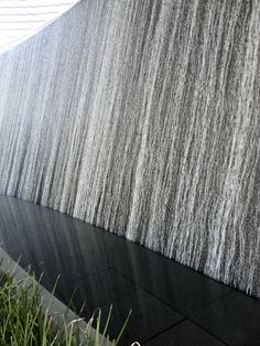 the wall is covered with water and grass