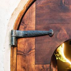 the door is made of wood and has an iron handle