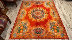 an orange and red rug is on the floor