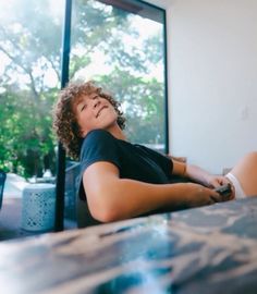 a woman laying on the floor with her legs crossed and eyes closed, looking up