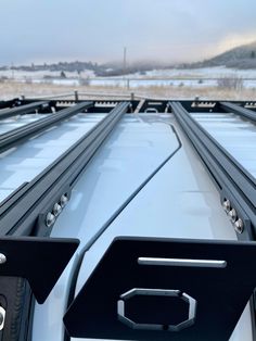 the back end of a truck with metal rails on it's flatbeds