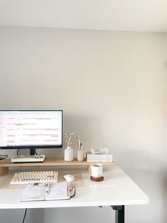 a white desk with a computer monitor and keyboard