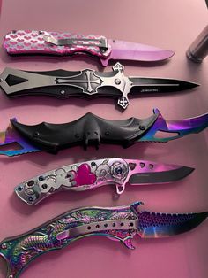 five different types of knifes on a pink countertop with one being cut open