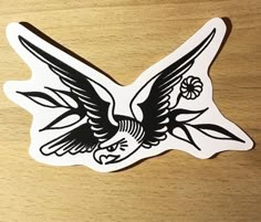 an eagle sticker sitting on top of a wooden table