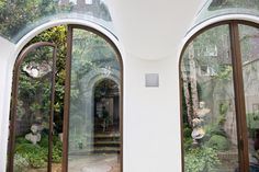 two arched glass doors open to the outside