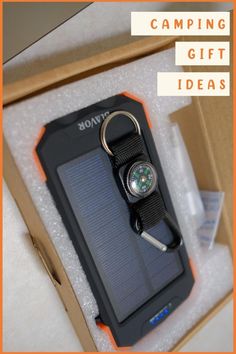 an open box with a keychain and a compass in it that says camping gift ideas