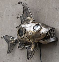 a fish shaped clock mounted to the side of a wall