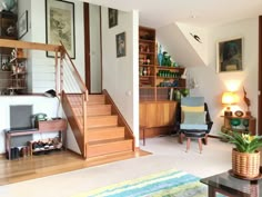 a living room filled with furniture and a staircase