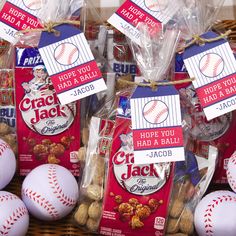 some baseballs are wrapped in plastic bags and sitting next to each other with tags on them