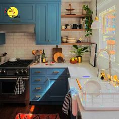 a kitchen with blue cabinets and white counter tops is pictured in this image, the light shines on the stove top