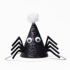 a black party hat with eyes and spider legs