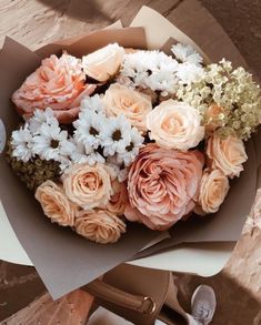 a bouquet of flowers sitting on top of a table next to a pair of scissors