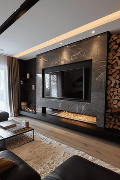 a living room with black furniture and a flat screen tv mounted to the side of a wall