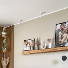 a living room filled with furniture and pictures on the wall