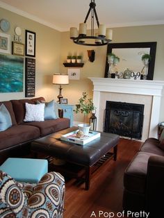 a living room filled with furniture and a fire place under a chandelier in front of a fireplace