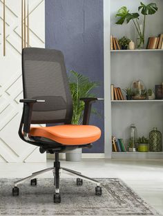 an office chair in front of a bookcase with books and plants on the shelves