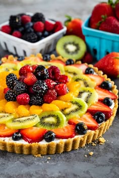 a fruit tart with berries, kiwis and strawberries