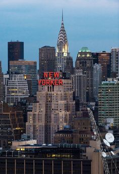 the new york city skyline is lit up at night with red letters that read new york