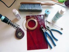 various crafting supplies on a table including scissors, thread, glue and other items