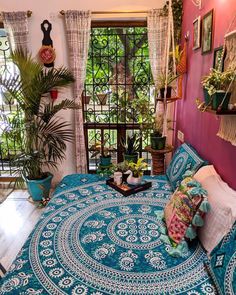 a bed with a blue and white bedspread in a bedroom next to a window