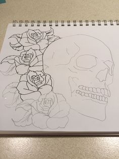 a drawing of a skull with roses on it