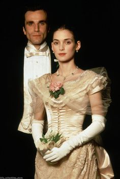 the man and woman are dressed in period costumes