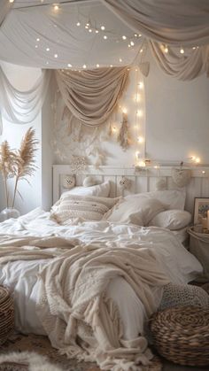 a bed with white sheets and lights hanging from the ceiling