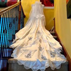 a bride's wedding dress on display at the bottom of stairs