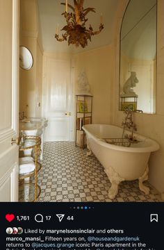 an old fashioned bathtub in a bathroom with a chandelier hanging from the ceiling