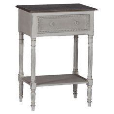 a small grey table with drawers on it's sides and an open drawer at the top