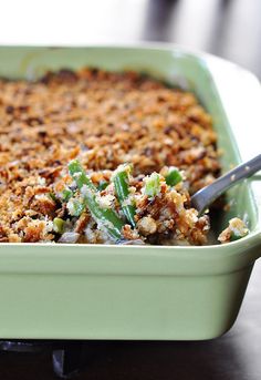 a casserole dish with green beans and crumbled toppings on top