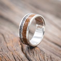 a wedding ring with wood and silver inlays