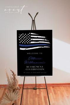 a welcome sign with an american flag and thin blue line in the background on a easel