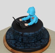 a cake made to look like a person on a laptop