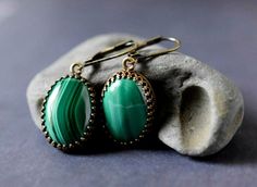 "Malachite Earrings - Cabochon Emerald Green Earrings - Antique Gold Bezel - Gemstone Jewelry - Personalized Gift .. .. .. Gorgeous artisan handcrafted natural stone malachite earrings feature brilliantly polished cabochon malachite gemstones. Rich lush forest green, emerald, and light green hues display unique striped patterns. Each stone is extremely beautiful high quality Grade B. I carefully hand set each gemstone in high quality open back crown trim edged styled antiqued gold brass plated b Green Malachite Bohemian Jewelry, Emerald Cabochon Earrings For Gift, Emerald Cabochon Earrings As A Gift, Handmade Dark Green Jade Jewelry, Elegant Green Onyx Earrings For Gift, Handmade Green Agate Earrings, Handmade Green Malachite Jewelry, Green Onyx Jewelry With Matching Earrings, Oval Green Brass Jewelry