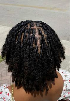 the back of a woman's head with dreadlocks