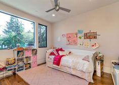 a bedroom with a bed, desk and window in it's centerpieces