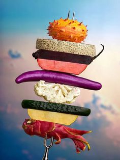 an assortment of vegetables stacked on top of each other in the shape of a stack