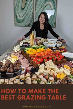 a woman sitting at a table full of food with the words how to make the best grazing table