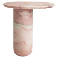 a pink marbled table with an oval shaped top and base, on a white background